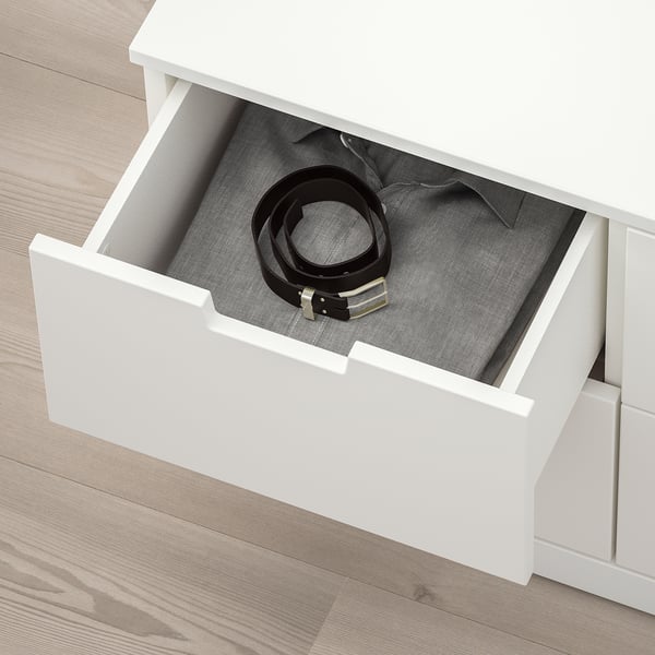 Open white chest drawer reveals neatly organised belt, highlighting NORDLIs practical storage solution.