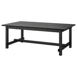 Black NORDVIKEN extendable dining table with wood, sturdy legs, and built-in extensions for modern interiors.