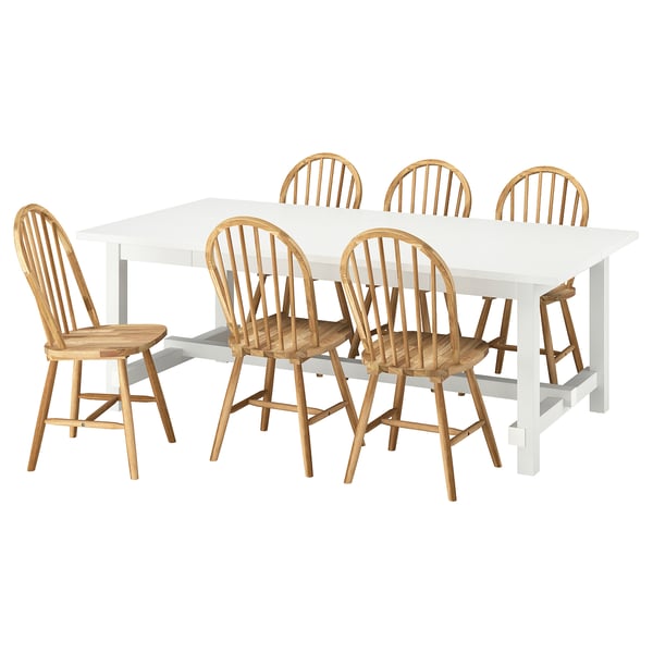 A white NORDVIKEN extendable dining table with six natural wood chairs.