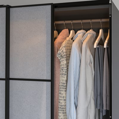 A modern wardrobe with led light strips illuminating clothes, automatically controlled.