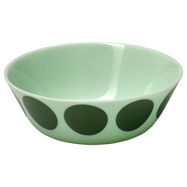 A green glass OFTAST bowl with larger dots on the bottom and smaller ones up the sides, round shape, clean-lined design.
