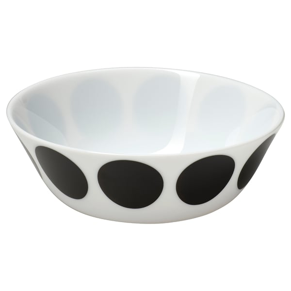 Black and white ceramic bowl with large circular dots on the exterior.