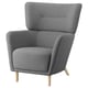 Displays a grey OSKARSHAMN armchair with a high back and winged sides, supported by light wooden legs and upholstered in a soft fabric.