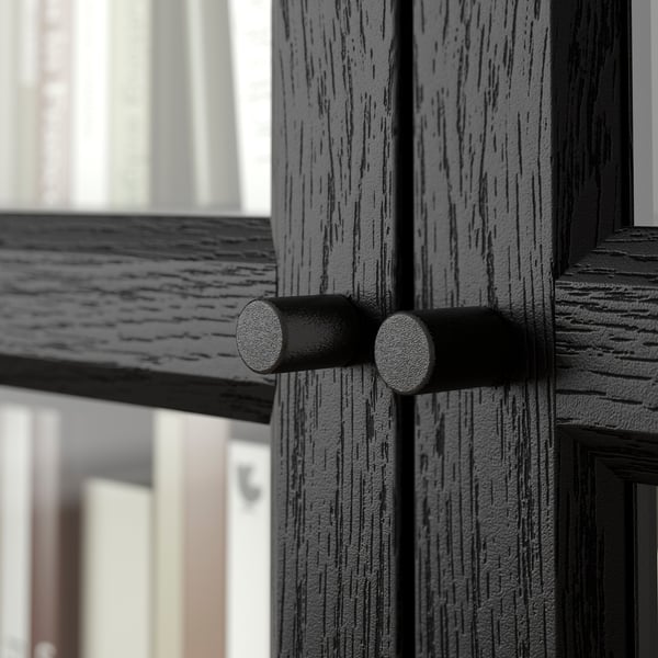 Black OXBERG door hinge on dark wood, showcasing sturdy build and sleek design.