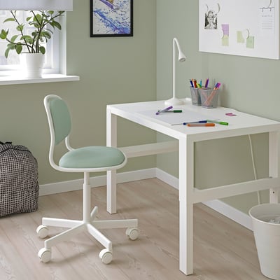 White kids desk & chair by PÅHL/ÖRFJÄLL. Minimalist design, green wall, plant, lamp, pencils.