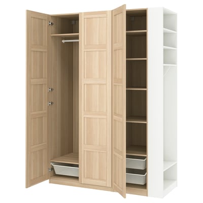 An open light wooden wardrobe named PAX with shelves and drawers.