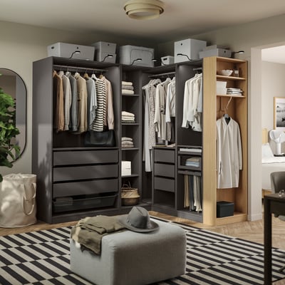 A modern walk-in closet with hanging clothes, shelves, and storage boxes. Includes drawers and hanging areas, useful for organising wardrobe items.