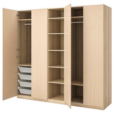 Light wood PAX wardrobe with open doors, shelves, and baskets.