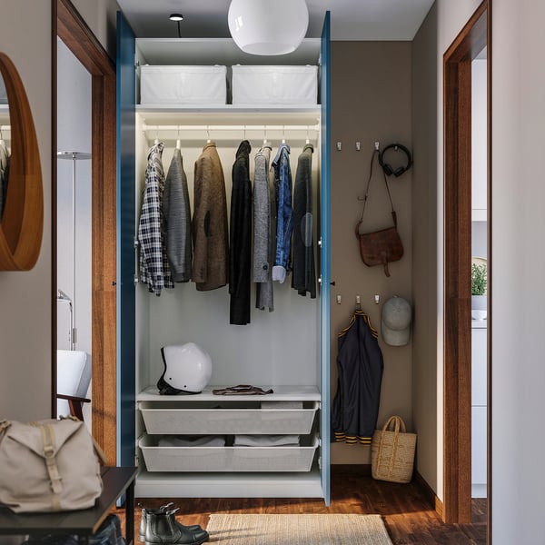 Open wardrobe with clothes and accessories inside. Includes shelves and hanging space. A helmet and bags are visible on the shelves.