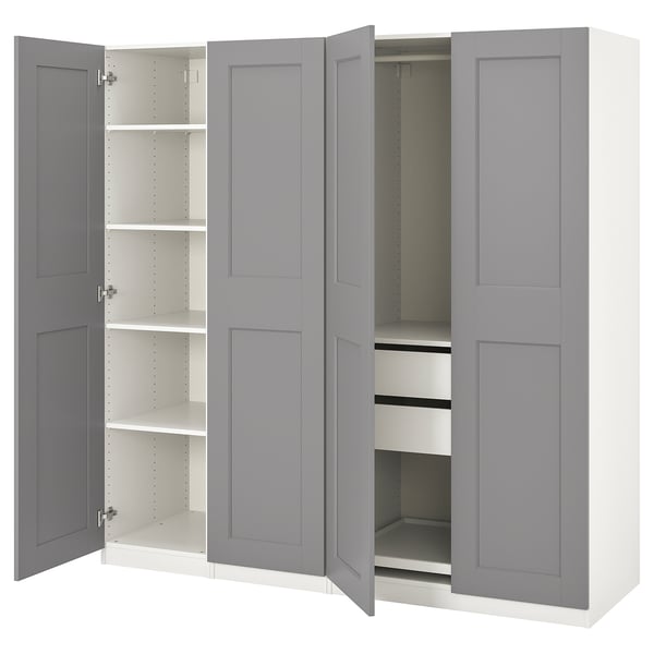 A grey ikea PAX wardrobe with open doors, revealing shelves and drawers inside.