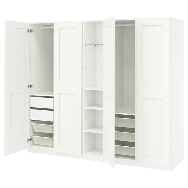This image shows a white IKEA PAX wardrobe with open drawers and shelves. It a minimalist design for organising clothes and accessories.