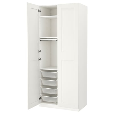 A white ikea PAX wardrobe with open doors, revealing shelves and mesh drawers.