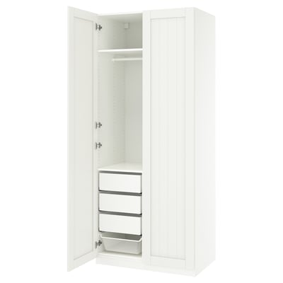 A white ikea PAX wardrobe with two doors open, revealing shelves and drawers.