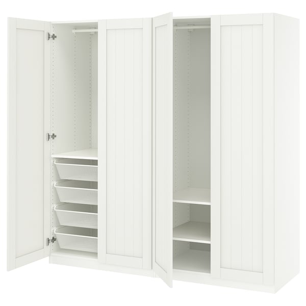 A white PAX wardrobe with open doors revealing storage shelves and mesh baskets for organising clothes.