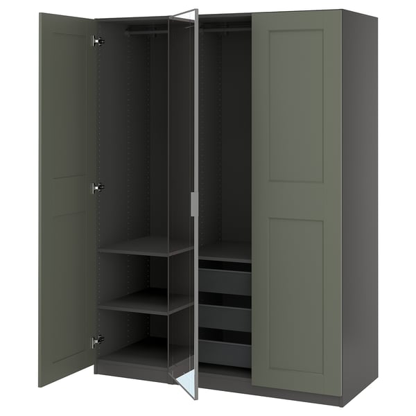A tall green PAX wardrobe with mirrored doors open, revealing shelves and a mesh basket inside.
