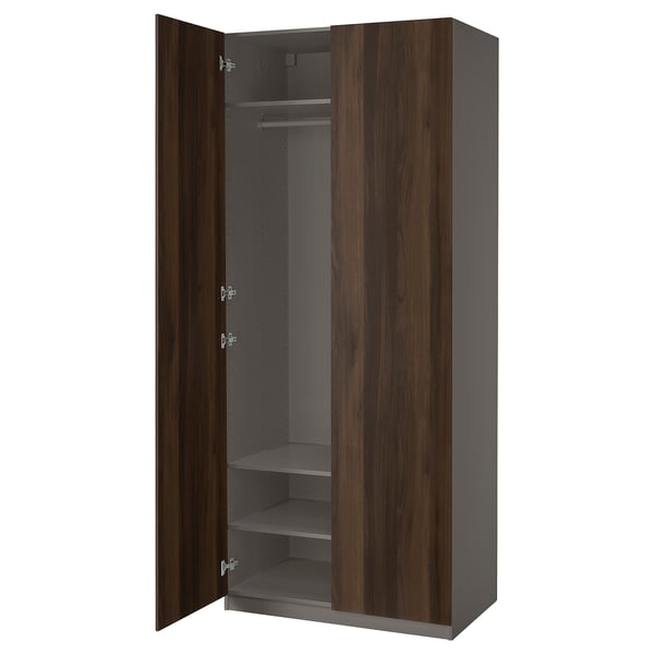 An open PAX wardrobe in dark brown. It a hanging rod and shelves inside.