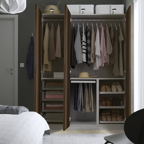 Wardrobe with hanging clothes, shoes, & folded items. Adjustable feet, adaptable storage for various needs.