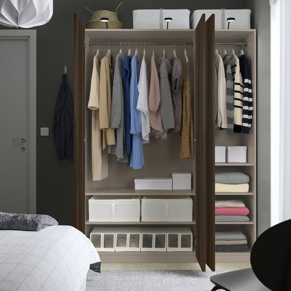 Open wardrobe with clothes, folded garments, and storage boxes. Adjustable feet and dampened hinges for slow door close.
