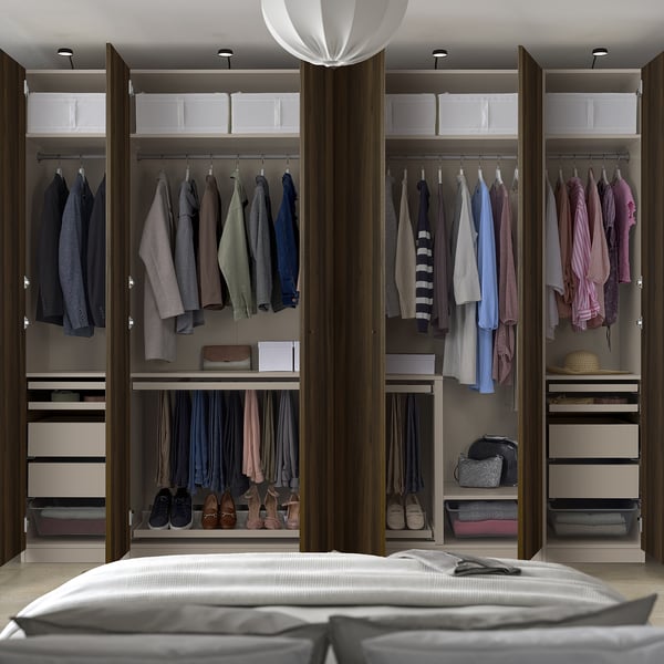 Modern walk-in closet with hanging clothes, shelves, and shoes. Wardrobe organises garments and accessories efficiently.