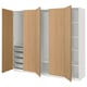 An open oak-colored ikea PAX wardrobe with shelves and drawers.