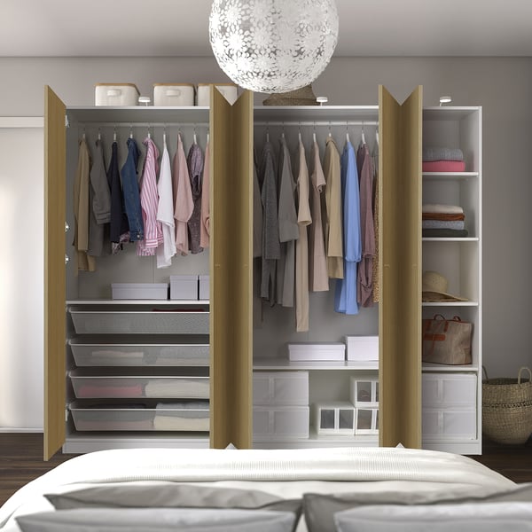 Open wardrobe with clothes, boxes, and baskets. Soft-close doors, adjustable shelves.