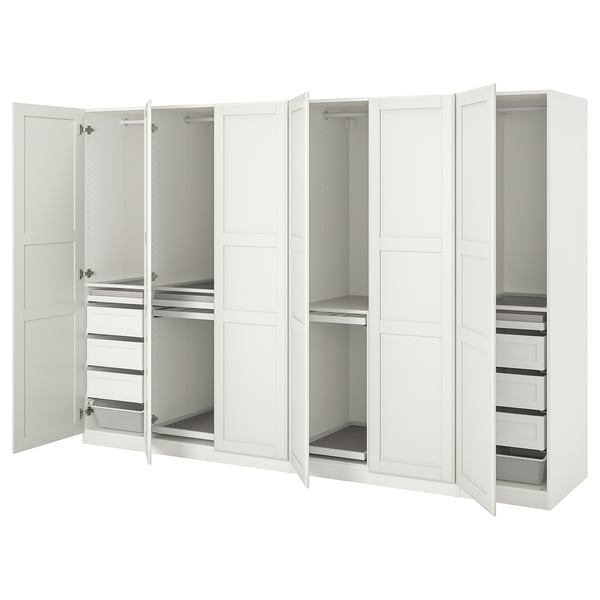White PAX wardrobe: six doors open to reveal shelf, hanging, and drawer storage. Modern, clean design in white.