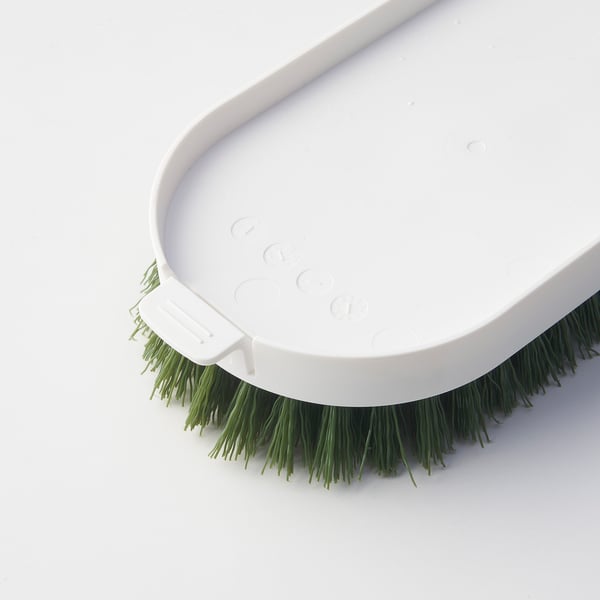 Close-up of PEPPRIG brush head refill with green bristles in a white holder.