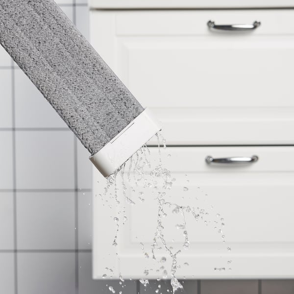 Foldable microfibre mop in use, showing water absorption and easy squeezing functionality.