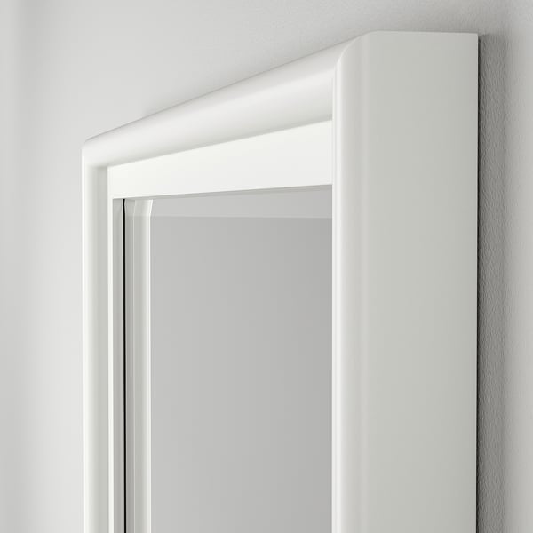 Pine-framed mirror with bevelled edges, sleek design, clean finish.