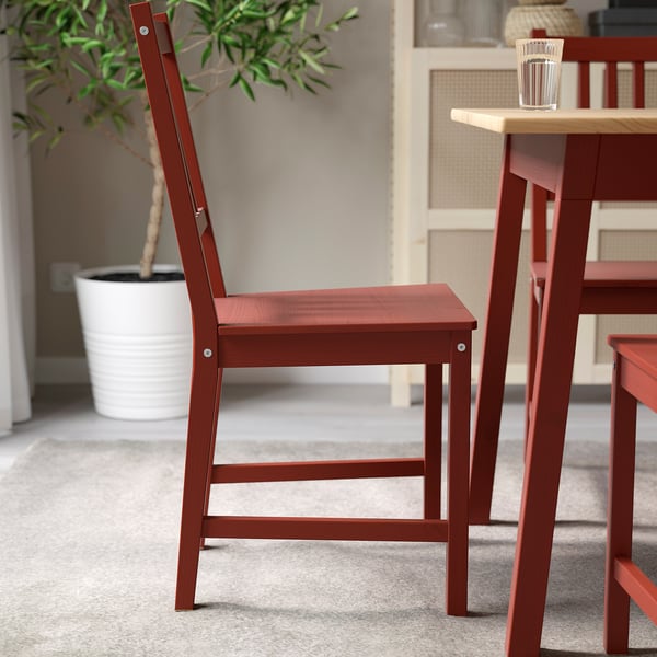 Red wooden chair with backrest slats, designed for match with table.