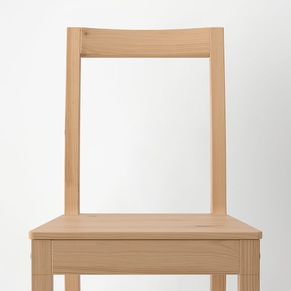 Wooden chair with natural finish, visible grain, sturdy frame, angled backrest.
