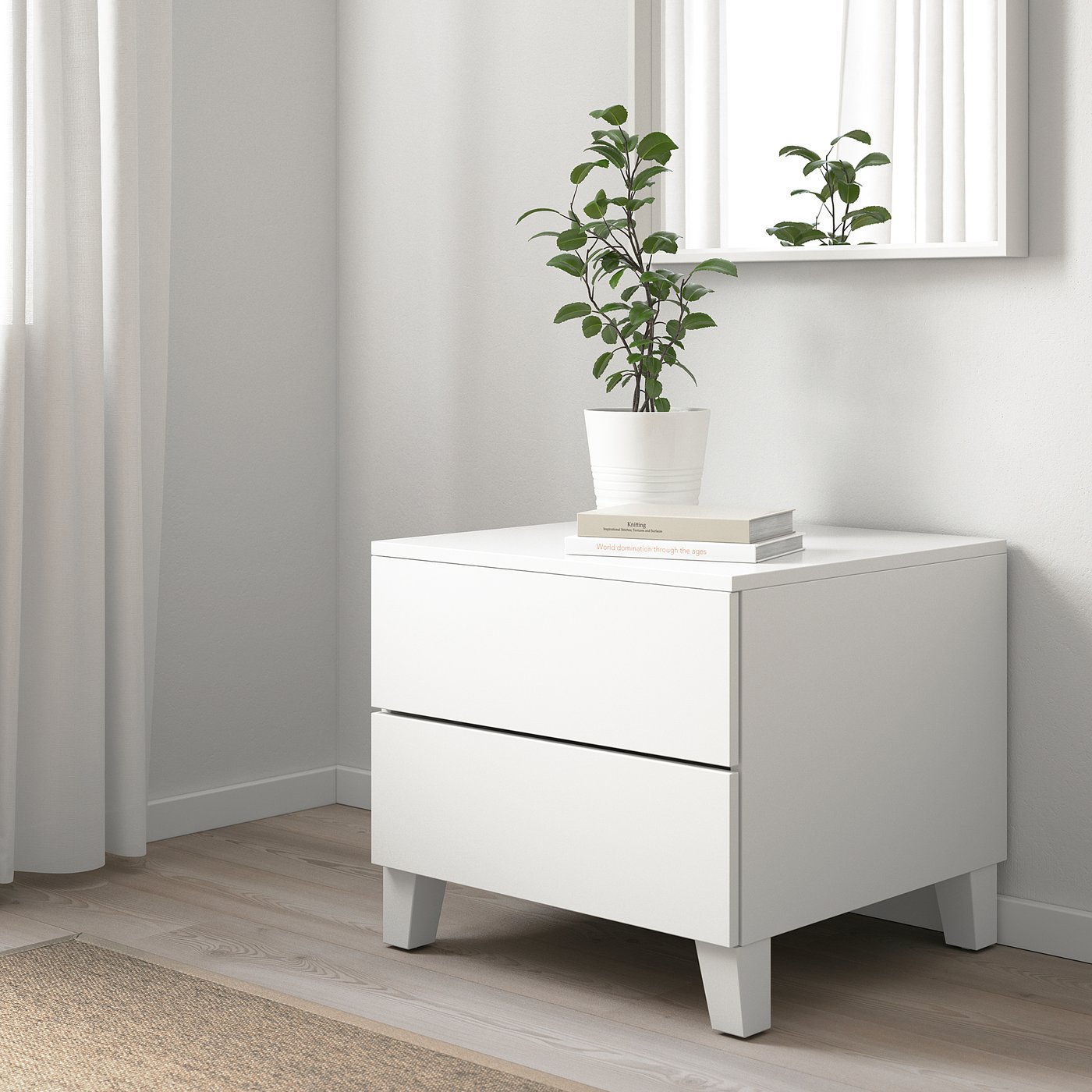 Modern white PLATSA side cabinet with two drawers, small indoor plant, light, square.