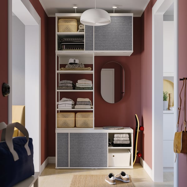 Modern closet with sliding doors and multiple shelves, showcasing organised clothes, accessories, and storage solutions.