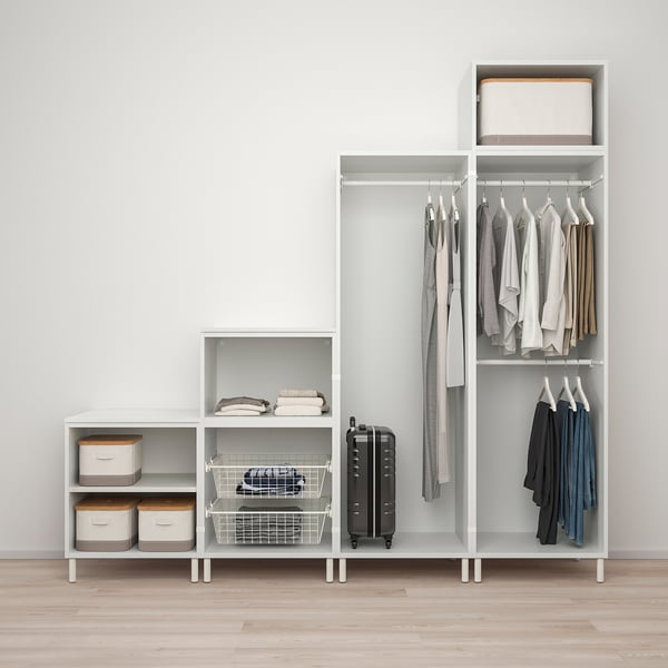 Modern white modular storage system with shelves and hanging garment rods, showcasing organised clothes and storage boxes.
