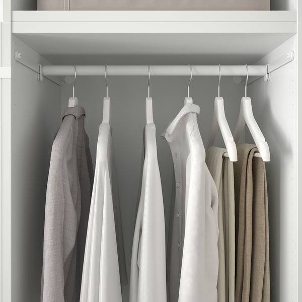A closet with PLATSA storage system, hanging clothes using hangers on a silver rod, organised neatly.
