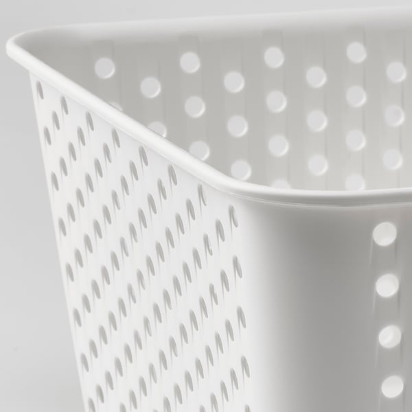 Close-up of white perforated storage basket; well-made, durable plastic with evenly spaced holes.