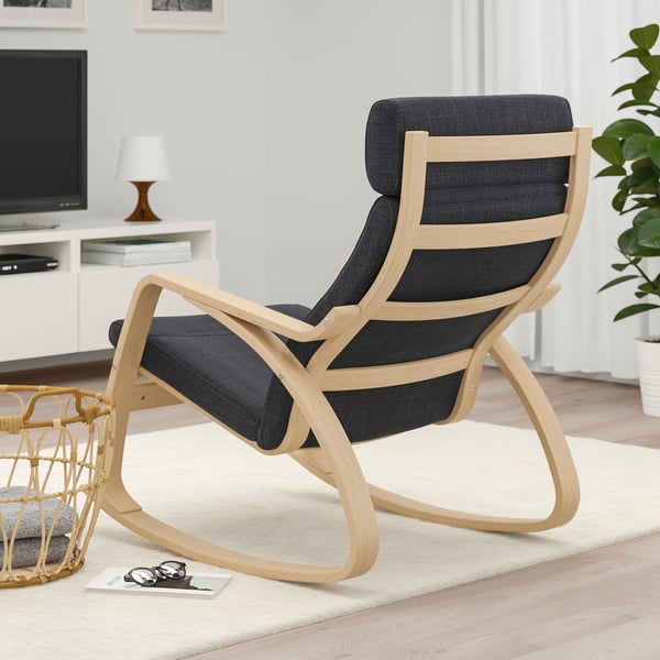 Dark cushioned rocking chair with light wooden frame in living room.