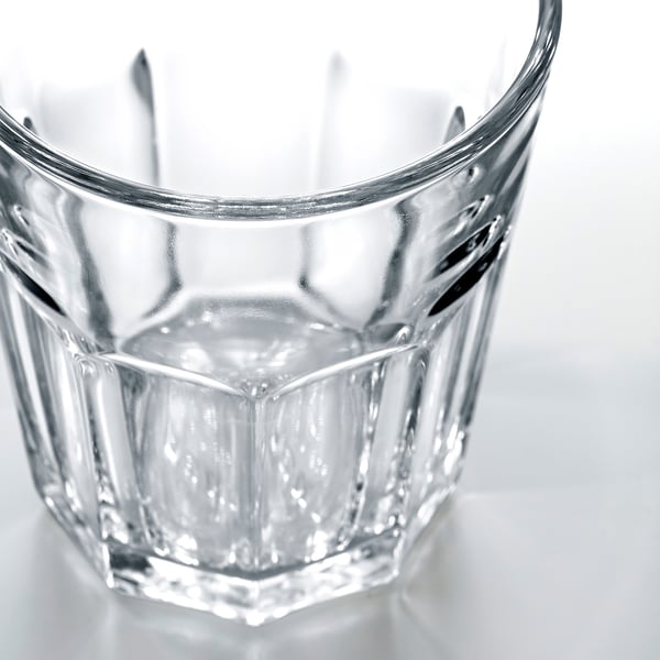 Glass tumbler with faceted design and smooth rim, empty, showcasing durability and clarity.
