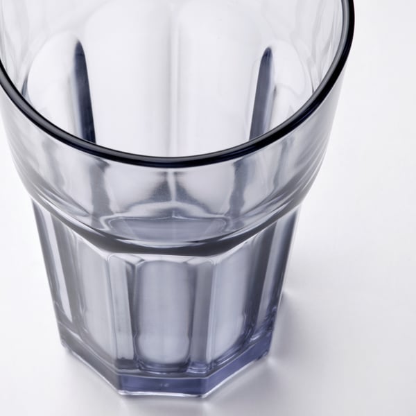 Transparent glass with dark rim, sturdy design.