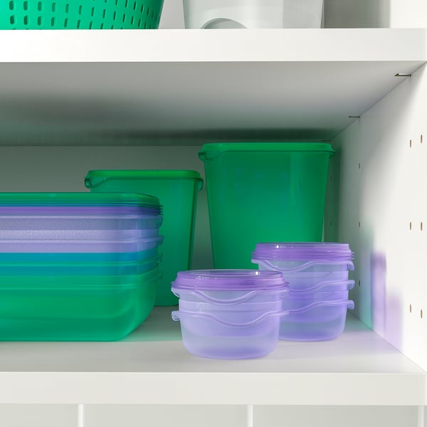 Kitchen shelf with stacked colourful food containers and lids for organised storage.