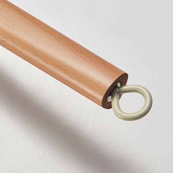 Wooden cooking utensil with metal ring handle. Light finish, smooth surface, clean design.