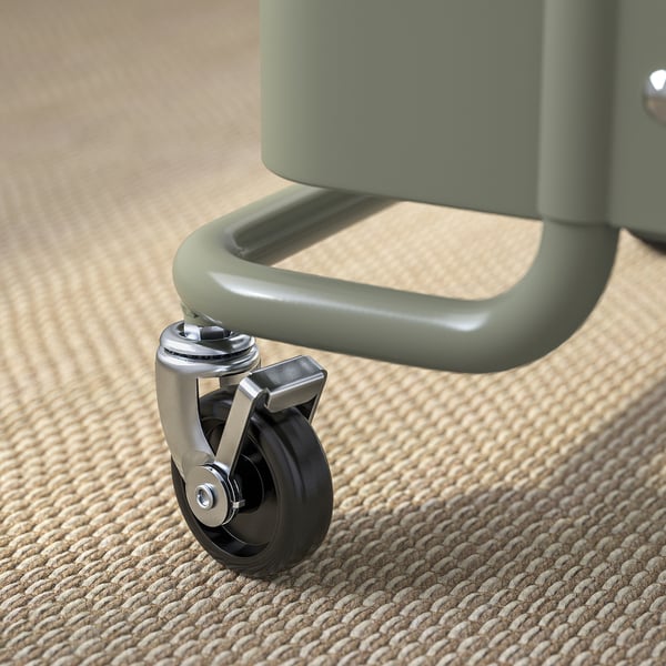 Close-up of a green office chairs caster wheel, showcasing high-quality materials and design.