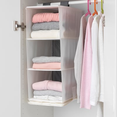 Hanging wardrobe organiser with five transparent compartments storing folded pastel-colored clothes, optimising closet space.