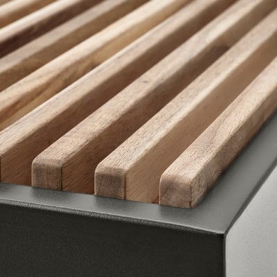 Close-up of slatted wood and black metal outdoor furniture; quality craftsmanship.