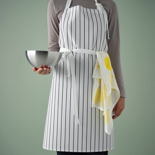 Person in striped white apron, holding bowl and towel, kitchen clean design.