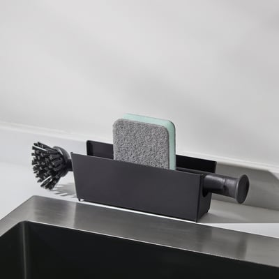 Black sink organiser with sponge & brush.