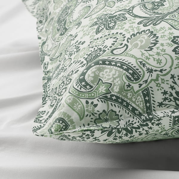 Paisley pillowcase close-up, intricate green patterns on soft, sheer fabric.