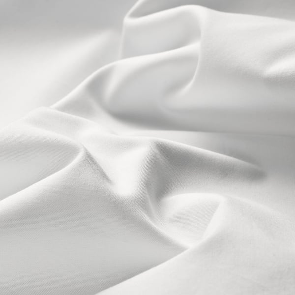 Crisp, white percale sheets displayed in a smooth, wrinkled texture, highlighting premium cotton quality.