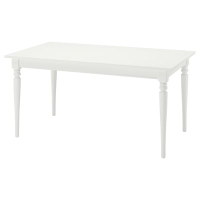 A white ikea ROSENTORP extendable dining table. Its rectangular, made of wood and melamine, with classic turned legs and a self-storing leaf.