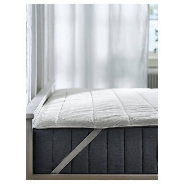 ROSENVIAL white mattress protector on bed, quilted, with strap corners.